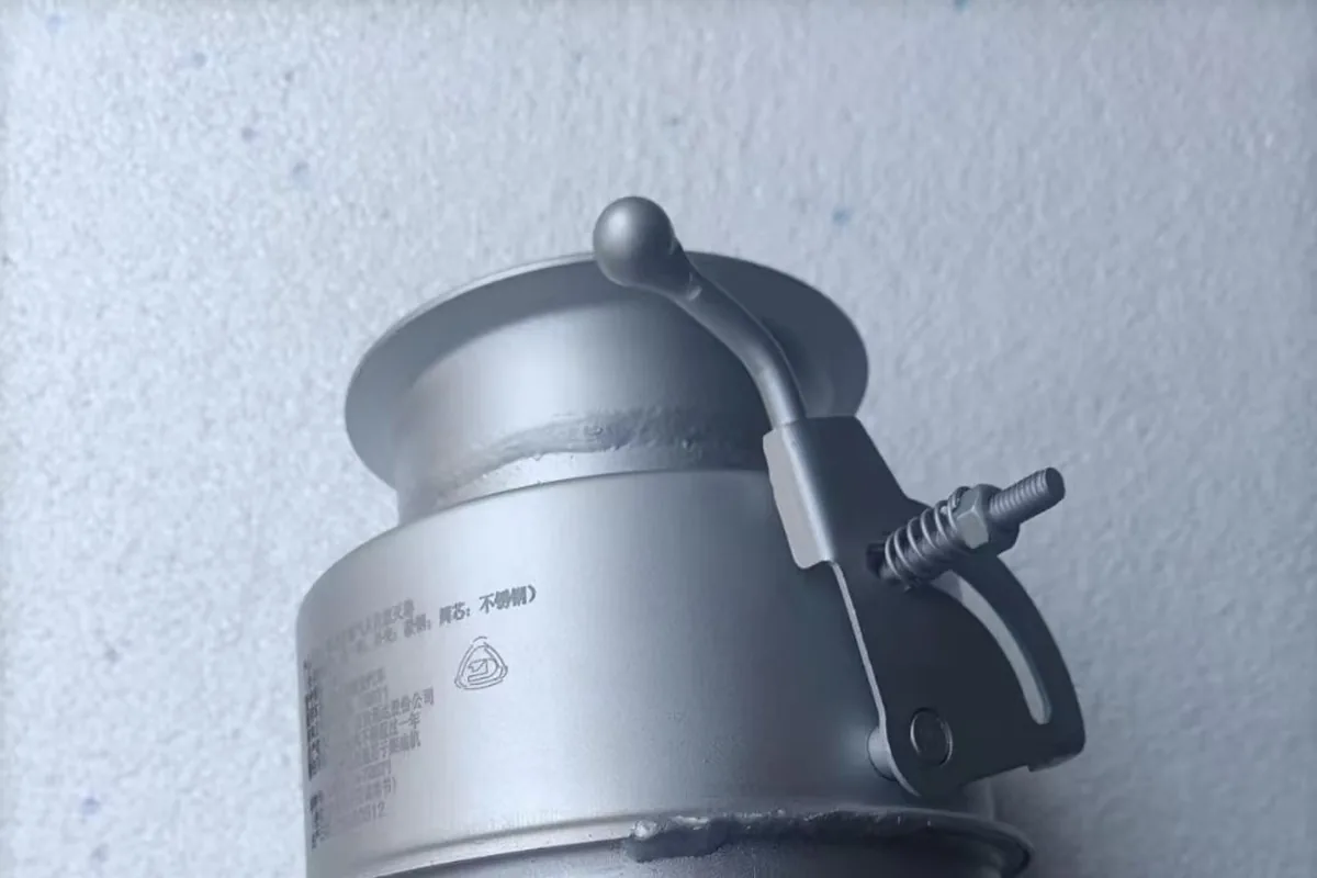 Compact exhaust canister assembly showing the external housing and clamp features