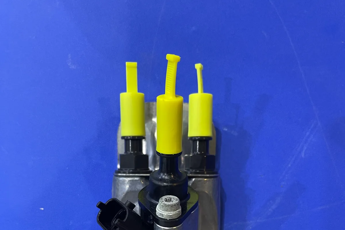 Urea pump assembly ports and electrical connector with protective caps fitted